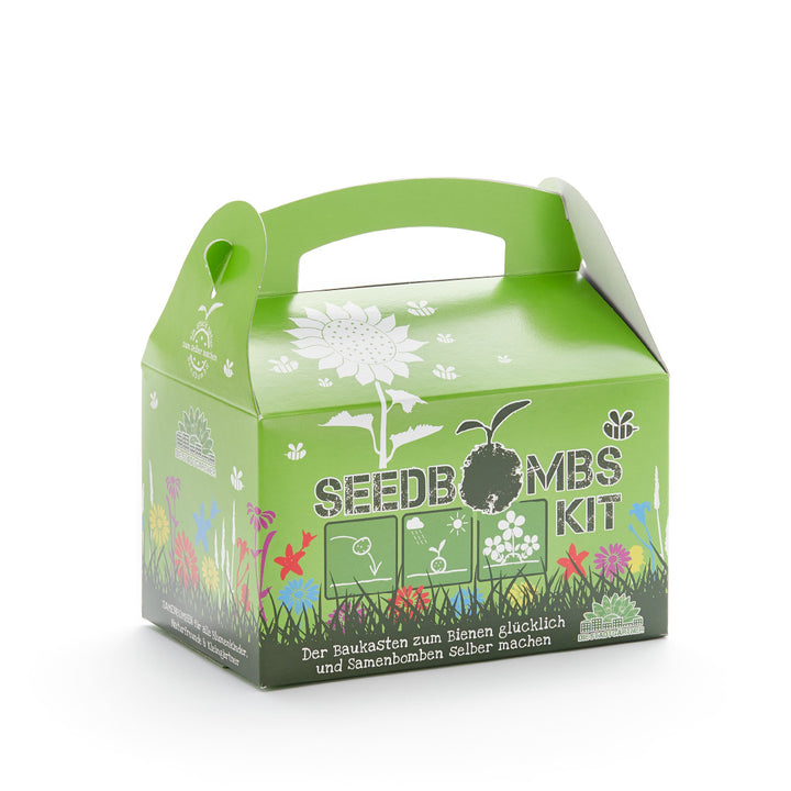 Grüne Verpackung eines Seedbombs Kit mit Aufdruck von Blumen und dem Slogan "Der Baukasten zum Bienen glücklich und Samenbomben Selber machen".