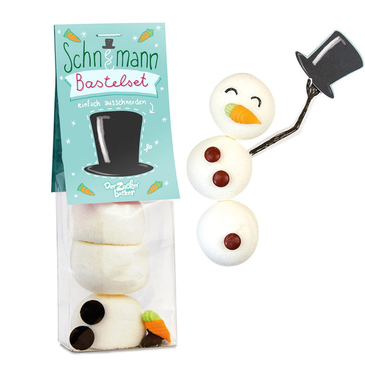 Ein Bastelset für einen Schneemann mit Zuckerteilen und einer Verpackung, die als Vorlage dient.