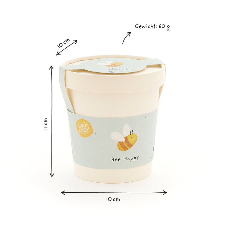Becher mit Deckel, hellblauem Bienenmotiv und Aufschrift "Bee Happy", Maße 11 cm hoch, 10 cm Durchmesser, Gewicht 60 g.