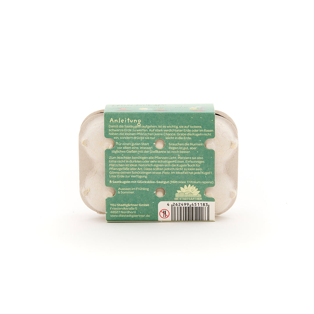 Eine kleine Verpackung mit Anleitungstext und Barcode, vermutlich für Saatgut, auf weißem Hintergrund.