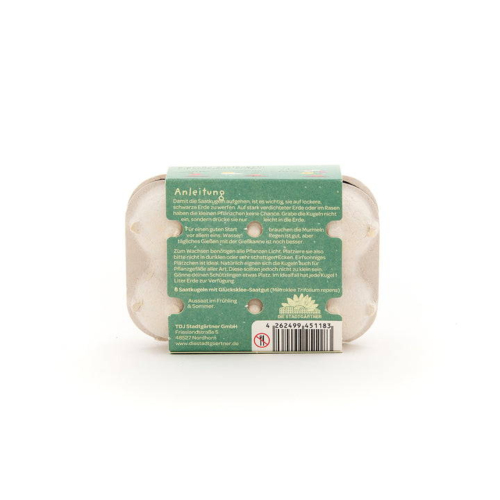 Eine kleine Verpackung mit Anleitungstext und Barcode, vermutlich für Saatgut, auf weißem Hintergrund.