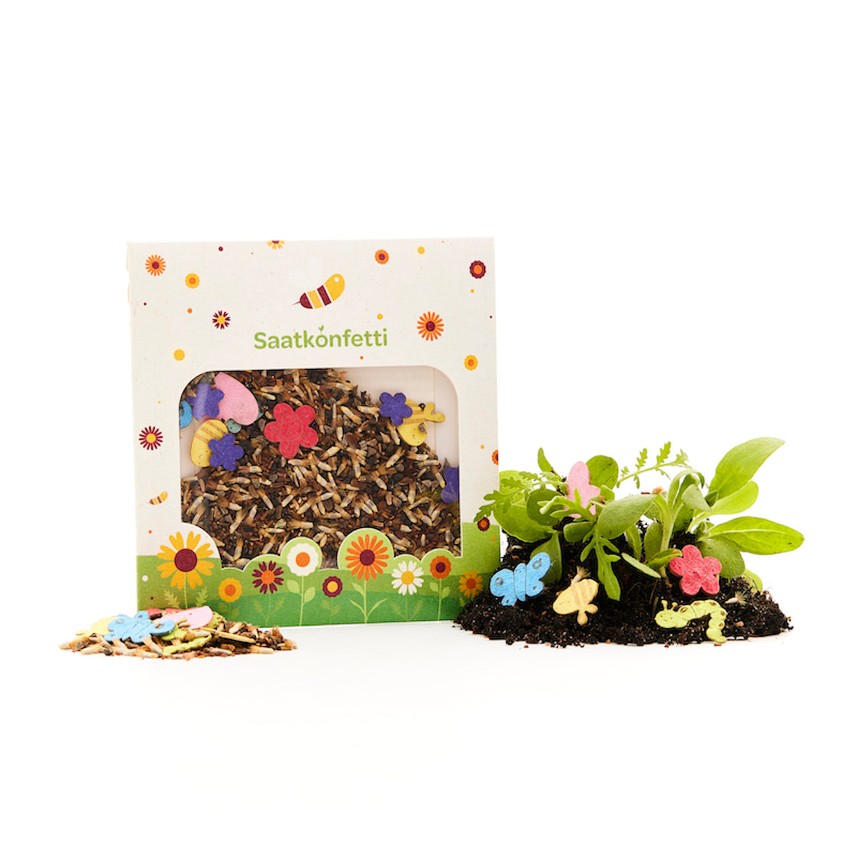 Eine Packung Saatkonfetti mit dekorativen Blumensamen und bunten Papierkonfetti in Blumen- und Schmetterlingsform, dazu Pflanzen, die aus Erde wachsen.