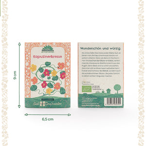 Zwei Packungen Kapuzinerkresse-Samen mit farbigen Blütenillustrationen, einer Beschreibung und Maßen von 9 x 6,5 cm auf hellem Hintergrund.