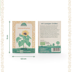 Zwei Sonnenblumen-Samentütchen der Marke „SaatGeschwister“ mit Maßangaben, Vorder- und Rückseite sichtbar; Vorderseite mit Sonnenblumenillustration, Rückseite mit Beschreibungstext und Barcode.