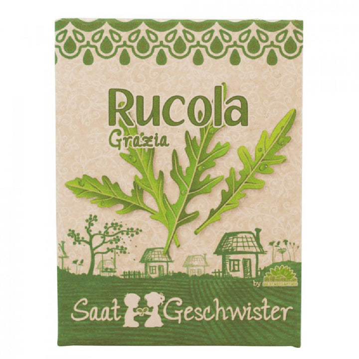 Verpackung für Rucola-Samen mit dem Namen "Rucola Grazia", illustriert mit Rucolablättern und einer ländlichen Szene inklusive Häuser und Figuren.