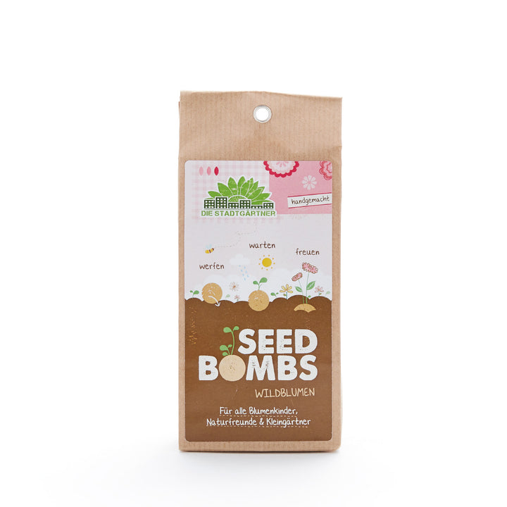 Verpackung von 'Seed Bombs Wildblumen' von 'Die Stadtgärtner' auf braunem Papier mit Blumenillustrationen und Text.