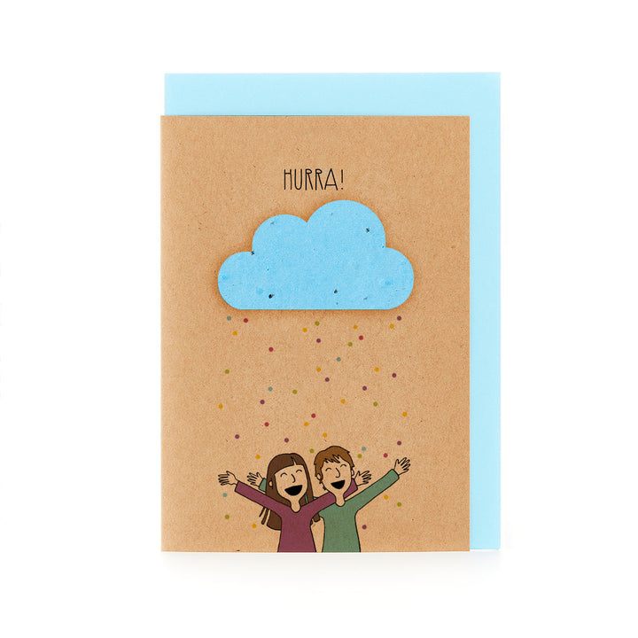 Glückwunschkarte mit dem Wort "HURRA!" über einer Illustration von zwei jubelnden Personen und einer blauen Wolke auf Kraftpapierhintergrund.