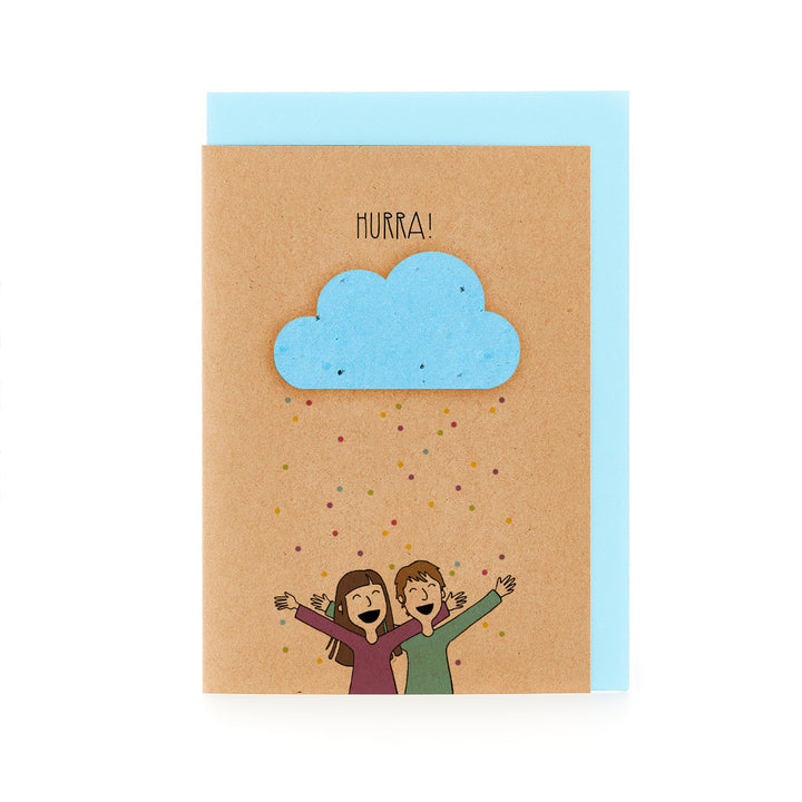 Glückwunschkarte mit dem Wort "HURRA!" über einer Illustration von zwei jubelnden Personen und einer blauen Wolke auf Kraftpapierhintergrund.